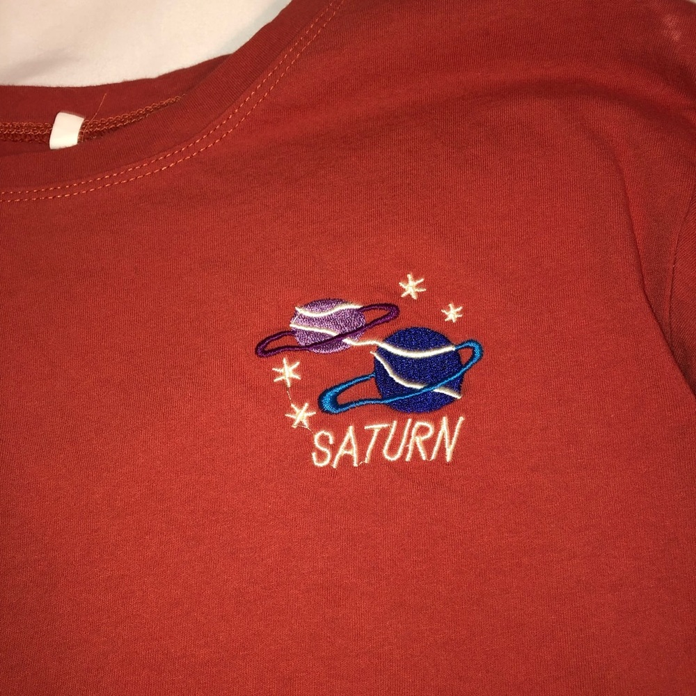 Orange “Saturn” vintage tee.